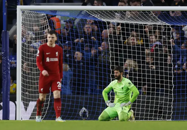 Liverpool players look deflated after conceding a second goal.