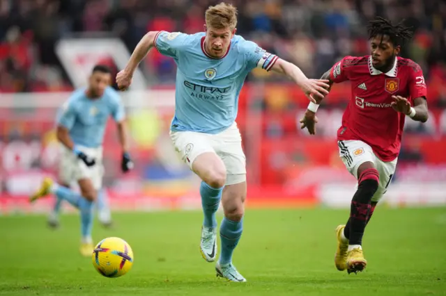 Man City's Kevin de Bruyne tries to evade the challenge of Man Utd's Fred.