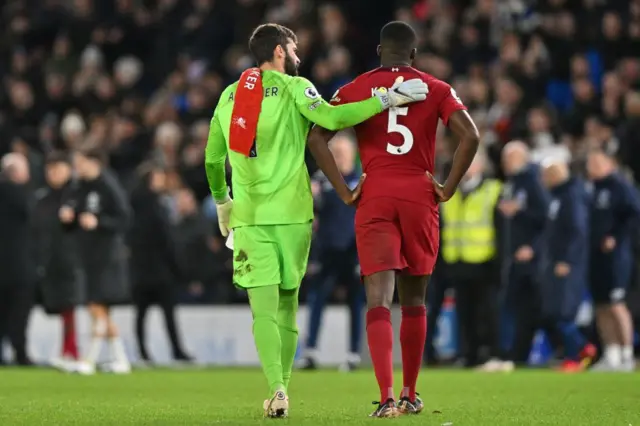 Alisson consoles Liverpool team-mate Ibrahima Konate.