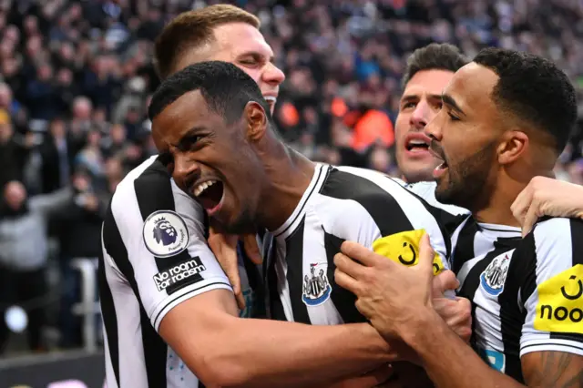 Alexander Isak celebrates his late goal with Newcastle team-mates.