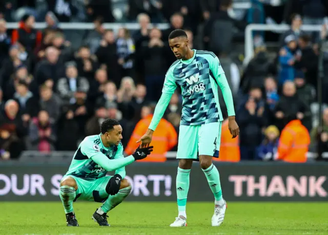 Fulham's Tosin Adarabioyo and Kenny Tete console one another after defeat.