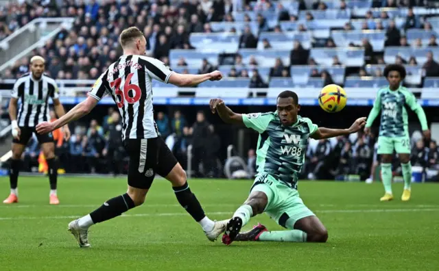 Sean Longstaff's effort is blocked by Fulham defender Issa Diop.