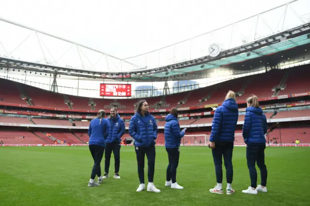 Chelsea players assess the pitch at the Emirates.