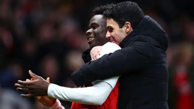 Mikel Arteta embracing Bukayo Saka