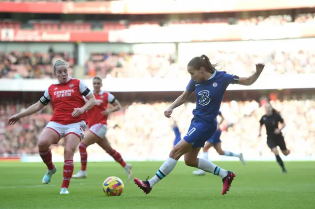 Arsenal captain Kim Little attempts to block Guro Reiten's cross into the box.