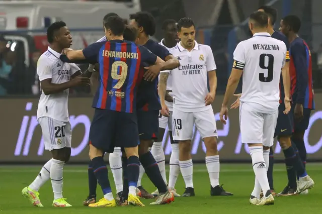The players of both teams get into a scuffle on the pitch.