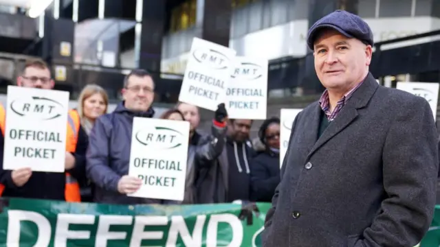 Mick Lynch, general secretary of the RMT, joins union members on the picket