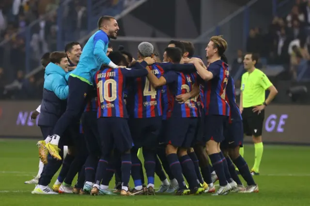 Barcelona players celebrate winning the Spanish Super Cup