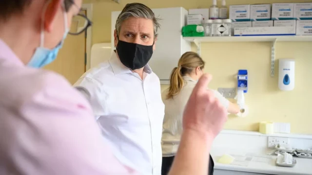 Keir Starmer visiting a hospital and talking to NHS staff