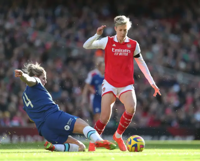 Arsenal's Lina Hurtig evades the tackle of Chelsea defender Millie Bright.