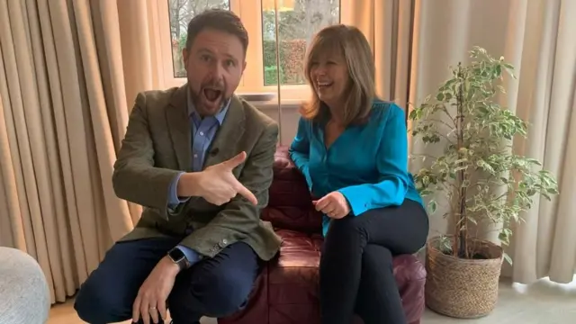 John with Debbie, who still has a piece of the original red sofa in her home