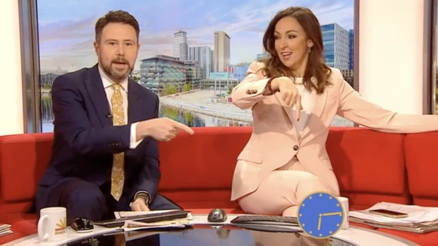 BBC Breakfast presenters sit with retro blue face clock