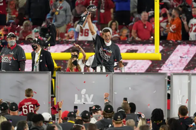 Tom Brady hoists the Vince Lombardi trophy