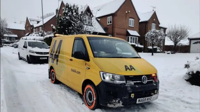 Picture of a yellow AA van parked in the snow