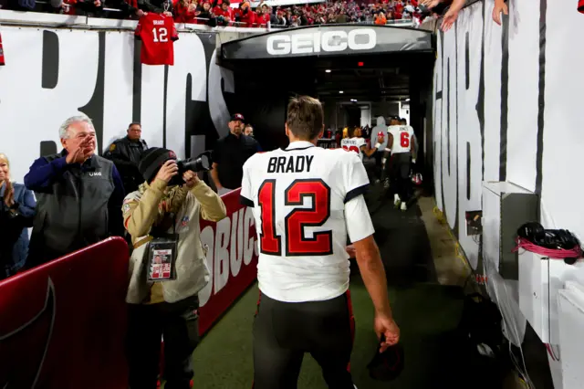 Tom Brady walks off the field