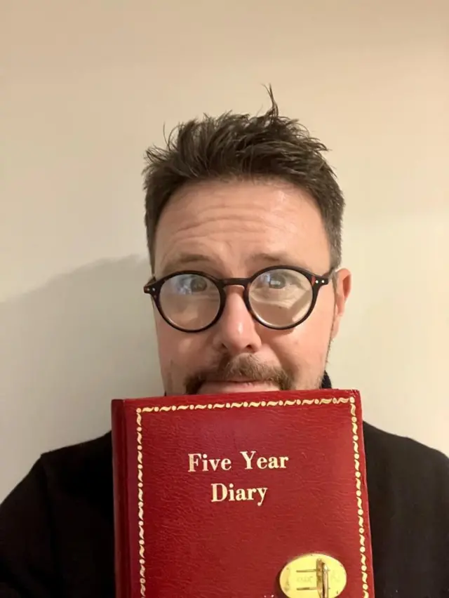 John Kay holding his diary