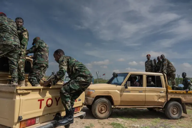 Soldiers of the Somali National Army (SNA) and Somalia security forces load onto vehicles at the airport in Baidoa, Somalia, on November 9, 2022.