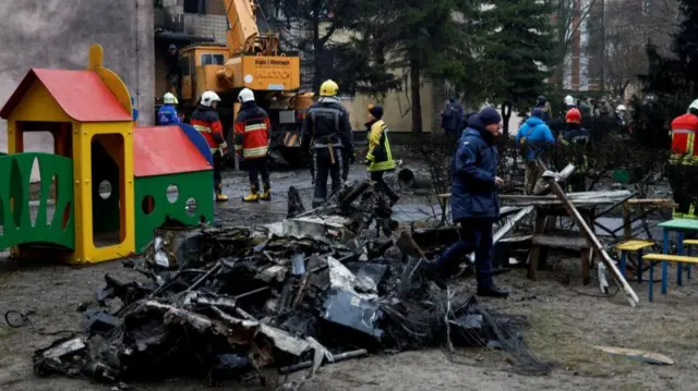 Emergency personnel work at the site of a helicopter crash, amid Russia's attack on Ukraine, in the town of Brovary, outside Kyiv, Ukraine