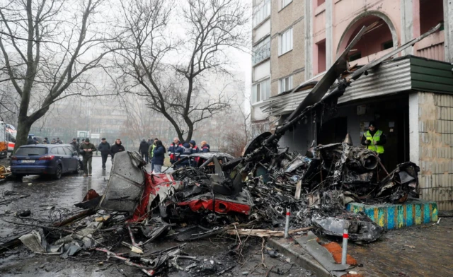 Rescue services working at the scene of a helicopter crash near the wreckage in Brovary