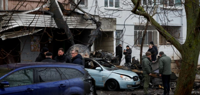 Debris from the helicopter crash lies on pavements and on cars