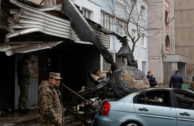 A view shows the site where a helicopter falls on civil infrastructure buildings, amid Russia's attack on Ukraine, in the town of Brovary, outside Kyiv,