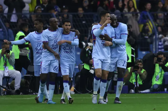 Cristiano Ronaldo celebrates after scoring his second of the match with teammates