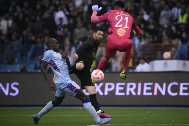 Leo Messi clips a finish past Saudi Arabia goalkeeper Mohammed Al Owais to score PSG's first goal