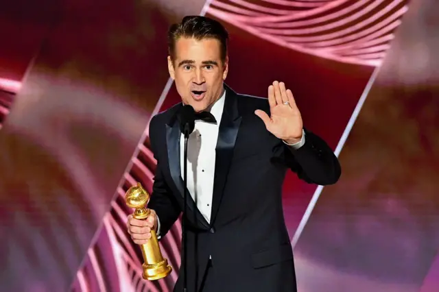 Colin Farrell holds an award on stage at the 80th Annual Golden Globe Awards