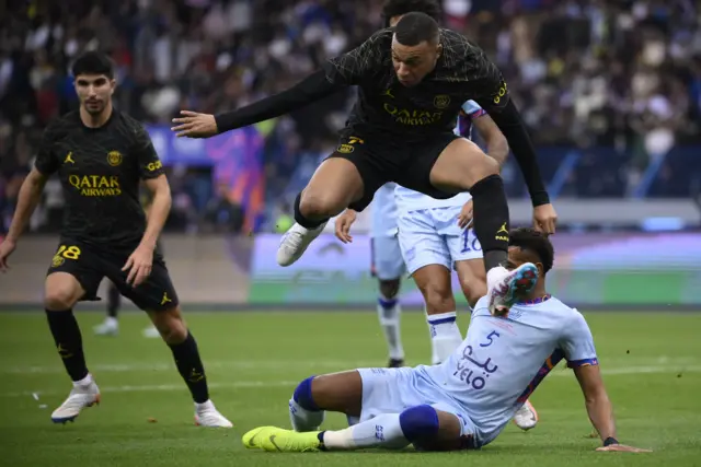 Kylian Mbappe jumps over the defender before playing a low cross across the six yard box