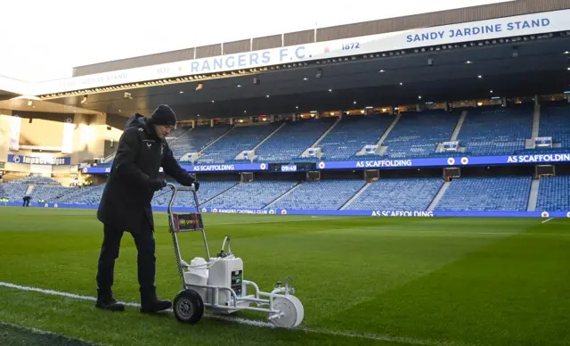 A groundsman lines the pitch before a cinch Premiership match between Rangers and Celtic at Ibrox Stadium