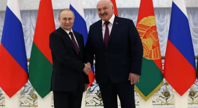 President Vladimir Putin shakes hands with Belarusian leader Alexander Lukashenko