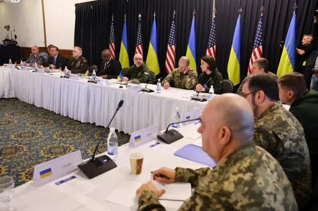 The meeting takes place at Ramstein Air Base in Germany