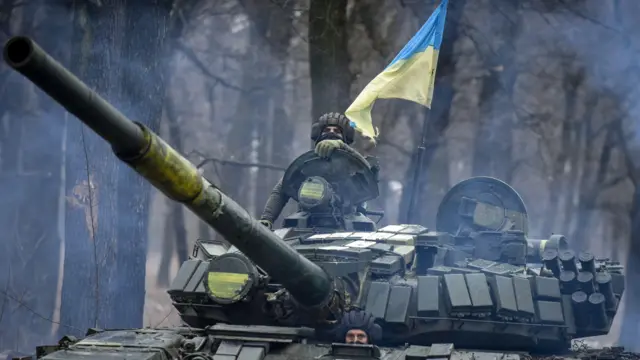 A Ukrainian T-72 tank manoeuvres through the trees in the Donetsk region, eastern Ukraine
