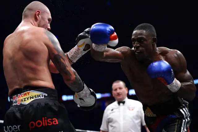 Richard Riakporhe throws a punch at Krzysztof Glowacki