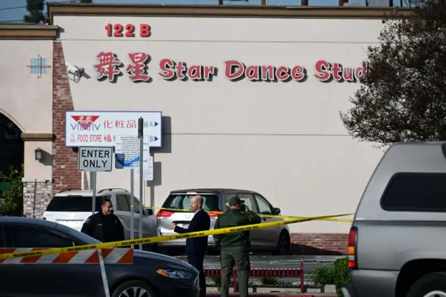 Investigators work at the scene of the mass shooting