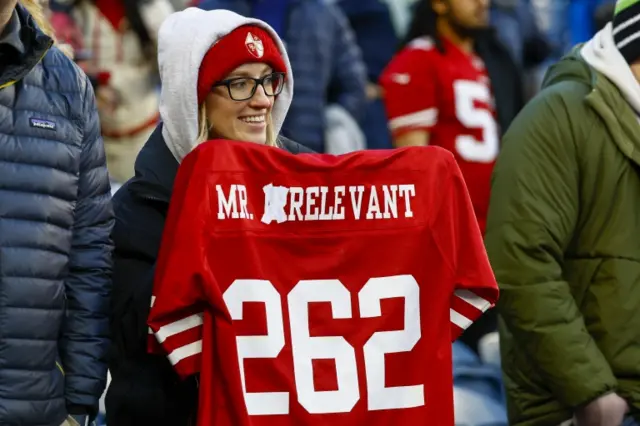 San Francisco 49ers fan holding a Brock Purdy 'Mr Relevant' jersey