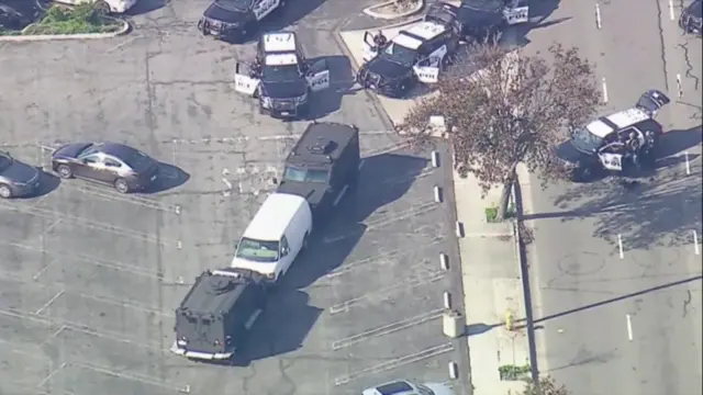 Police vehicles around a white van