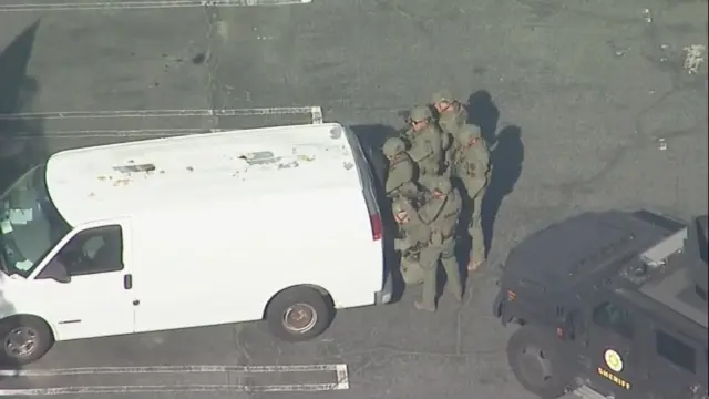 Swat officers search a white van in California