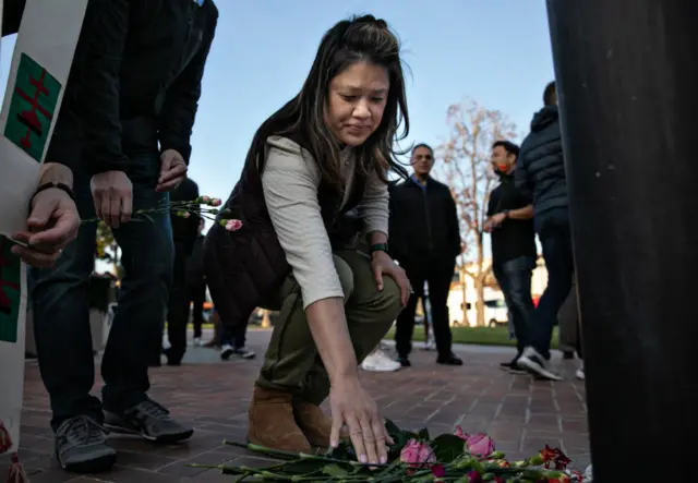 Woman lays flowers