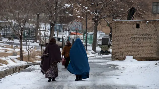 Afghan women walk in capital Kabul