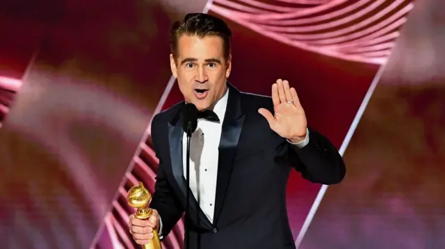 Colin Farrell holds an award on stage at the 80th Annual Golden Globe Awards