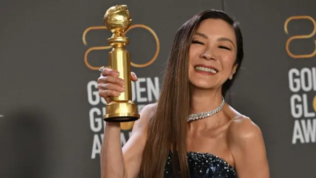 Michelle Yeoh poses with the award for Best Actress