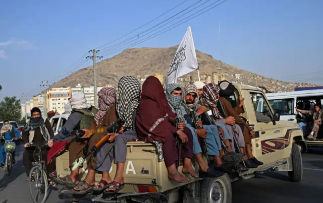 Taliban fighters in a vehicle patrol the streets of Kabul on August 23, 2021