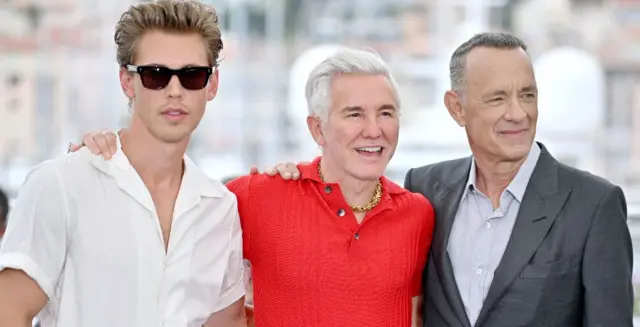 Baz Luhrmann pictured with Elvis stars Austin Butler and Tom Hanks