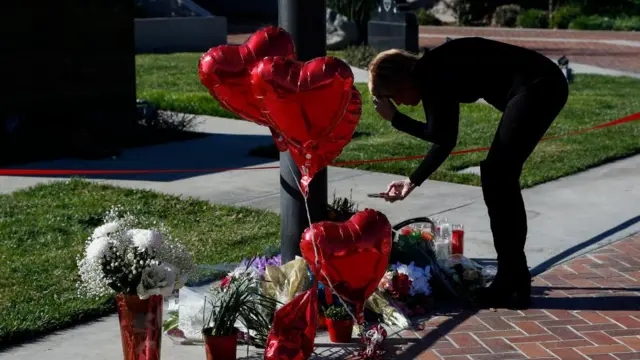 A person visits a makeshift memorial outside of Monterey Park City Hall in Monterey Park, California