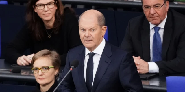 German Chancellor Olaf Scholz speaks in front of German Defense Minister Boris Pistorius during a session of questions addressed to the Federal Government at the German parliament Bundestag in Berlin