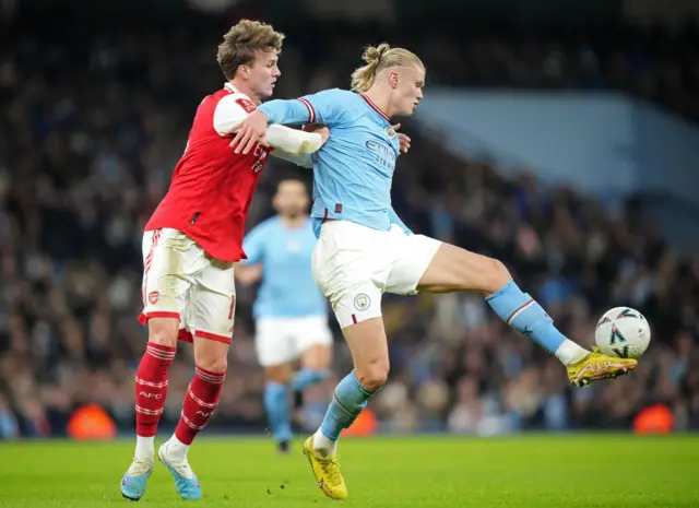 Rob Holding and Erling Haaland battle for the ball