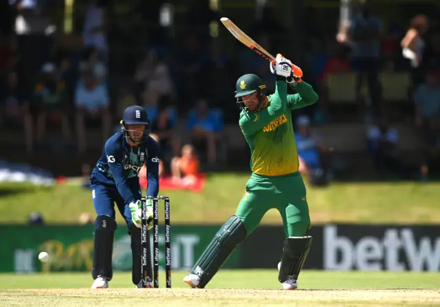 Heinrich Klaasen of South Africa plays a shot as England wicket keeper Jos Buttler looks on during the 1st One Day International between South Africa and England at Mangaung Oval