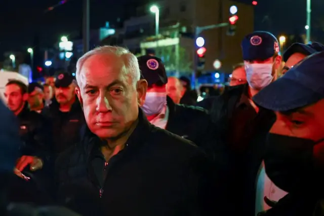 Benjamin Netanyahu surrounded by Israeli forces at the scene of the shooting in East Jerusalem