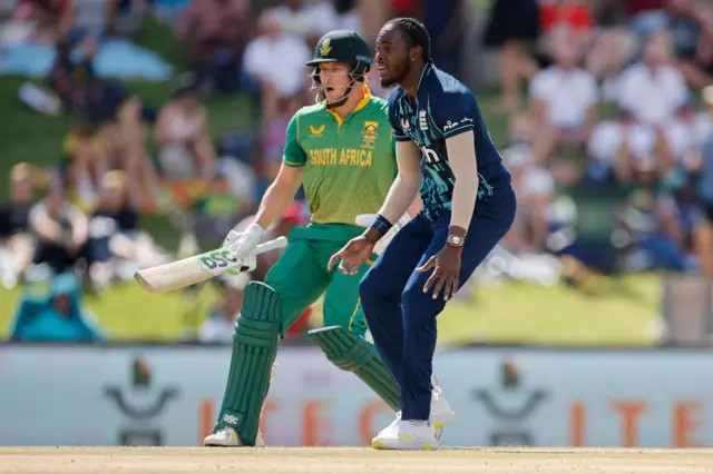 England's Jofra Archer (R) and South Africa's David Miller (L) react during the first one day international (ODI) cricket match between South Africa and England at Mangaung Oval in Bloemfontein on January 27, 2023.
